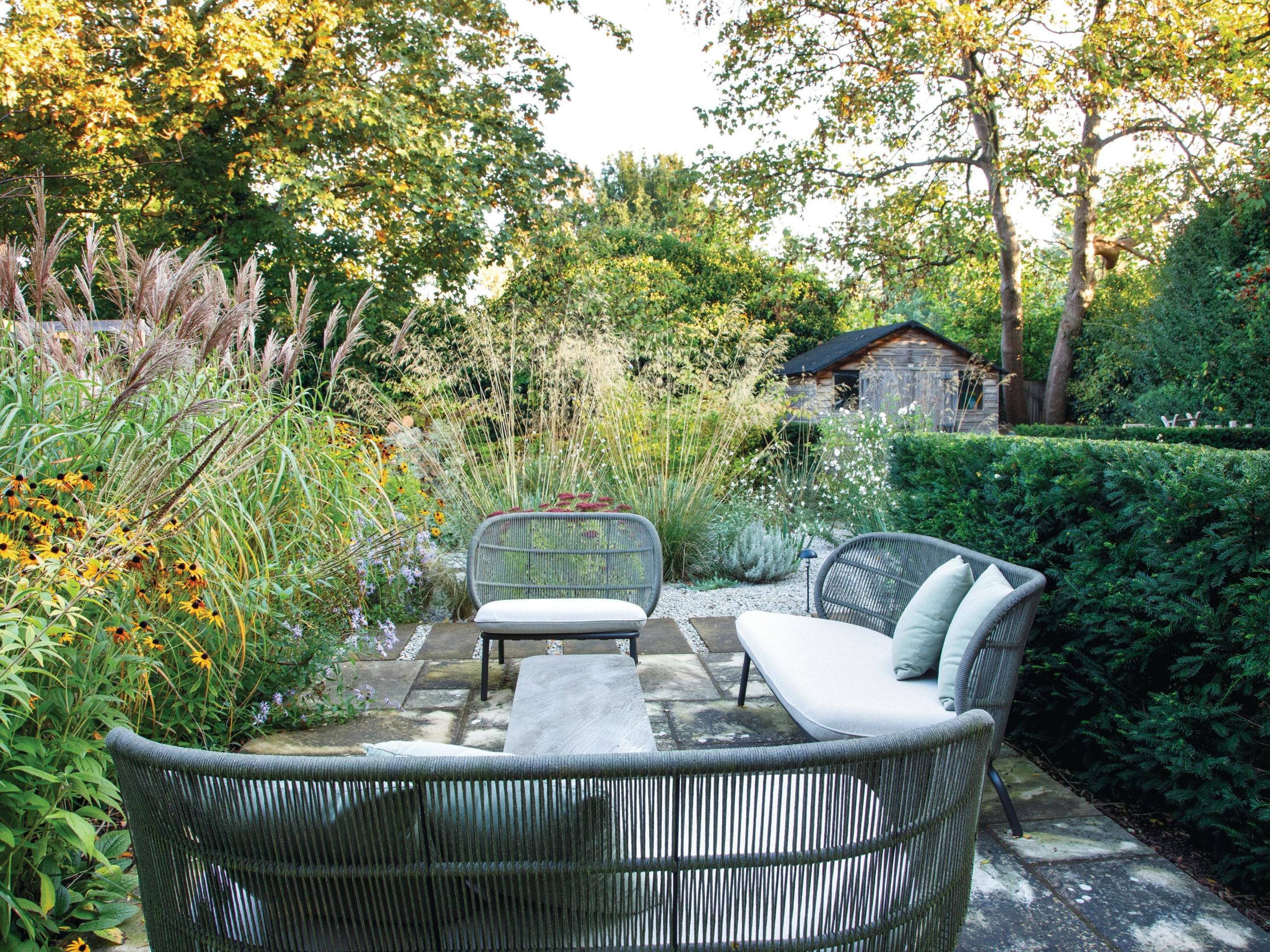 Garden seating area surrounded by trees
