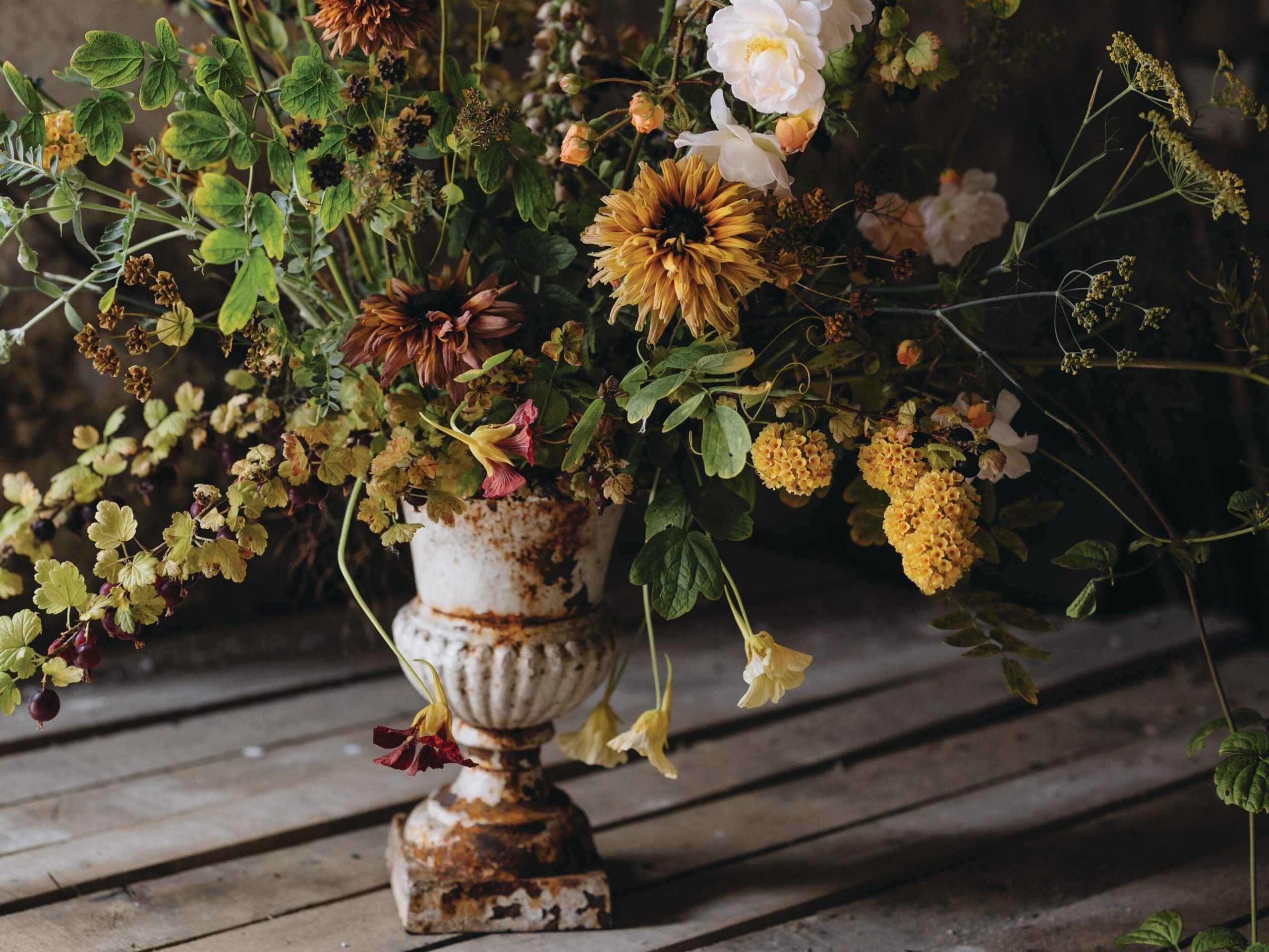 Flowers arranged in urn on table