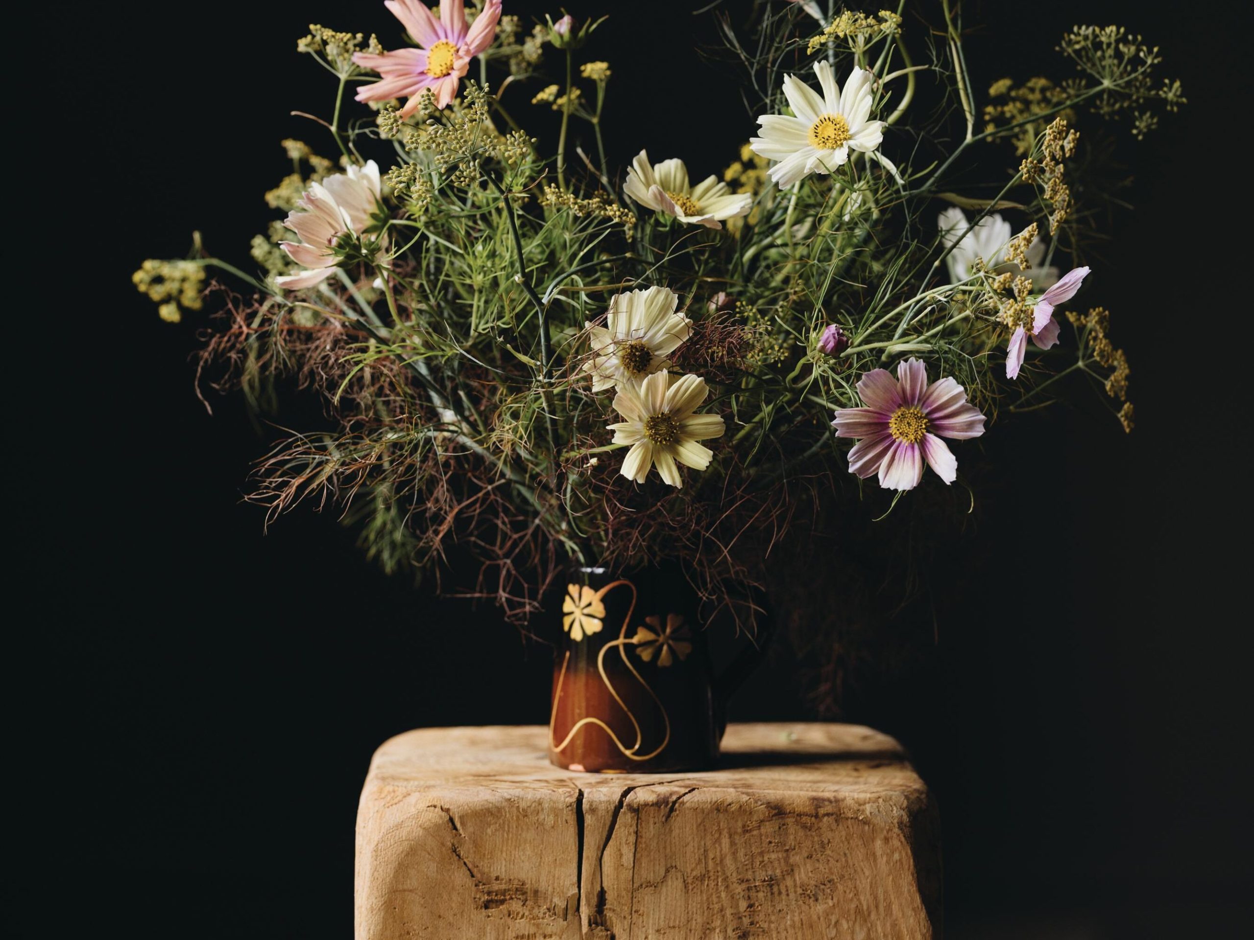 Flowers arranged in brown jug