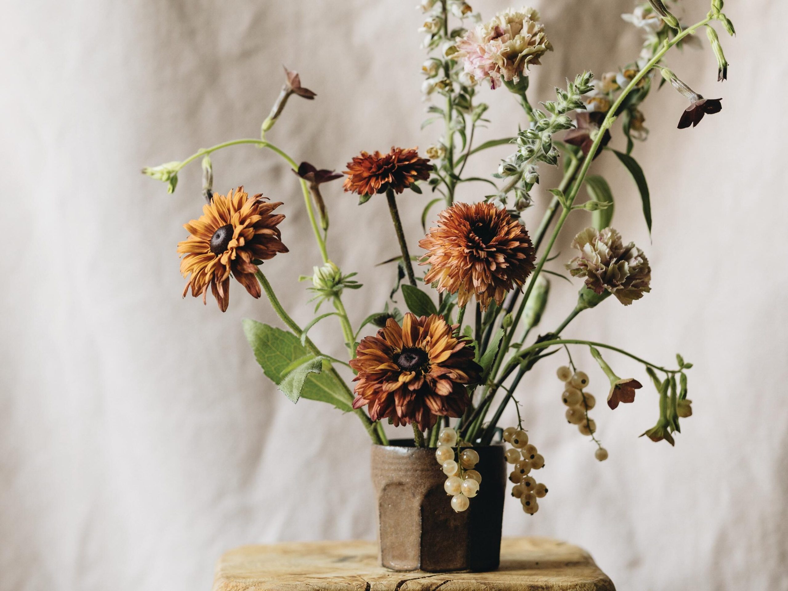 Flowers arranged in brown cup